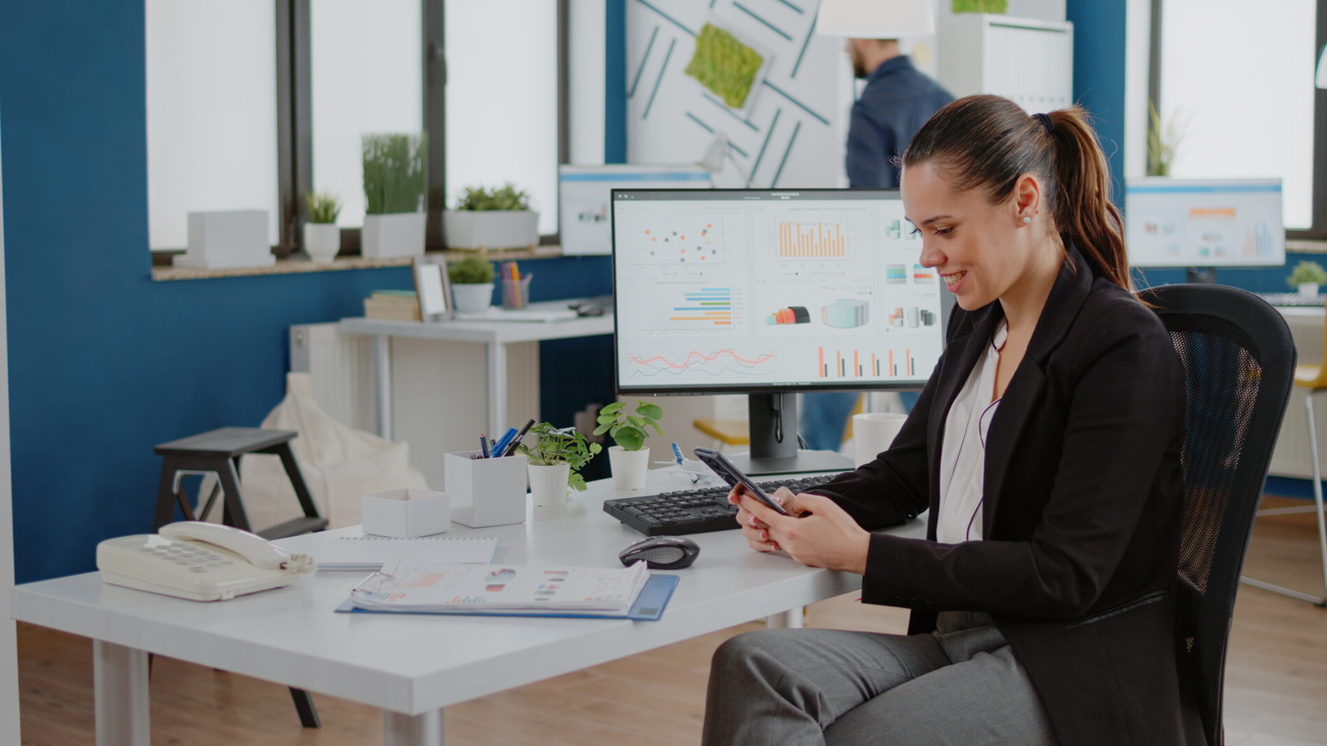 Corporate employee looking at smartphone screen